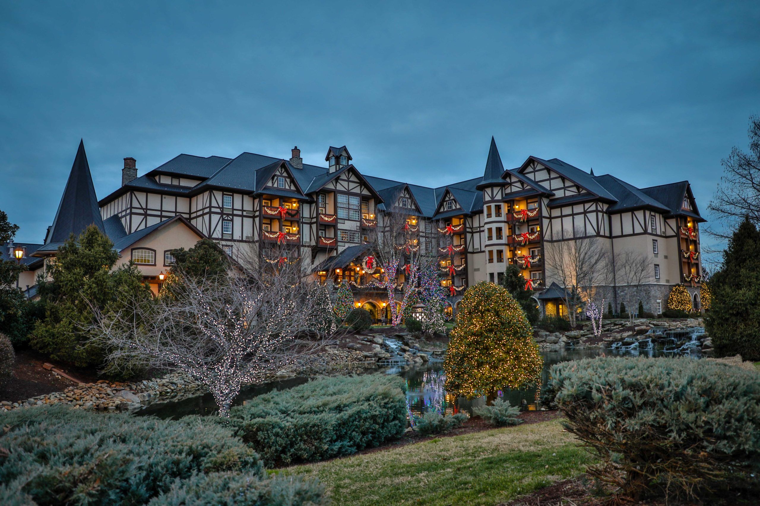 The Inn at Christmas Place at night under full holiday lighting