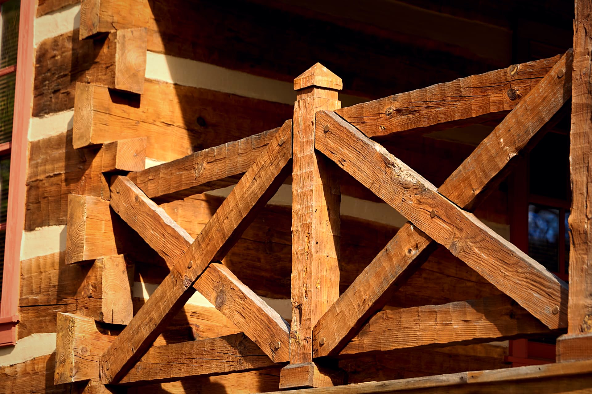 Timber railing post landing on a hewn log corner