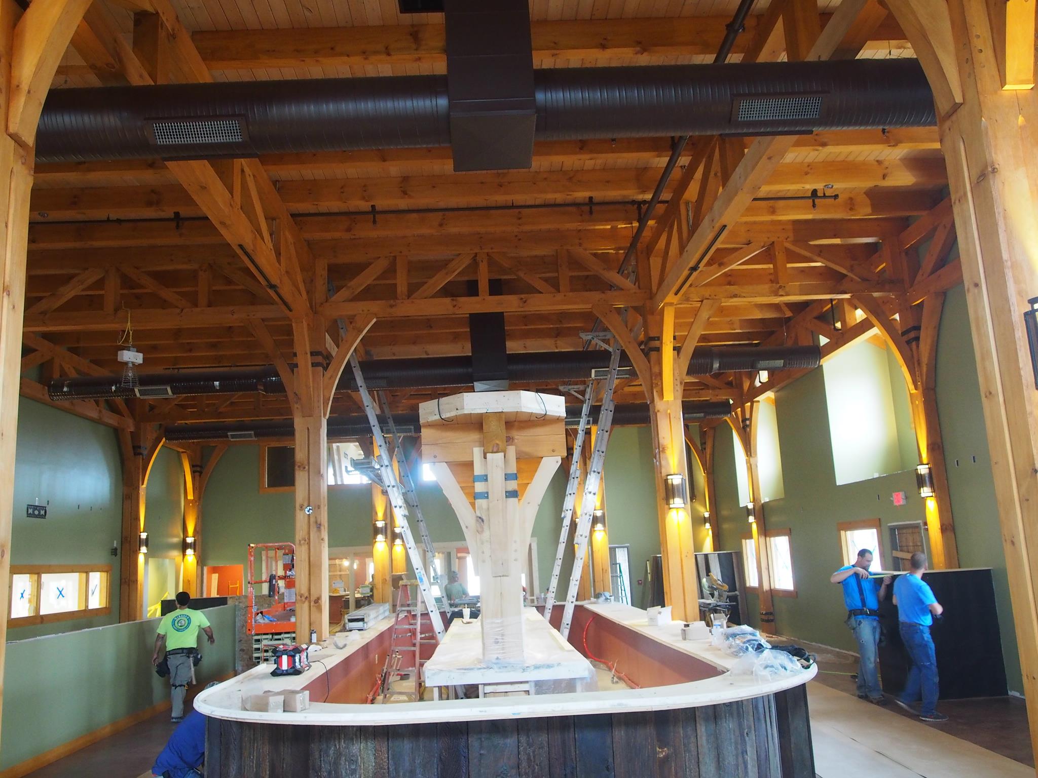 Big Woods Speedway — brewhouse tanks set inside the timber frame during fit-out