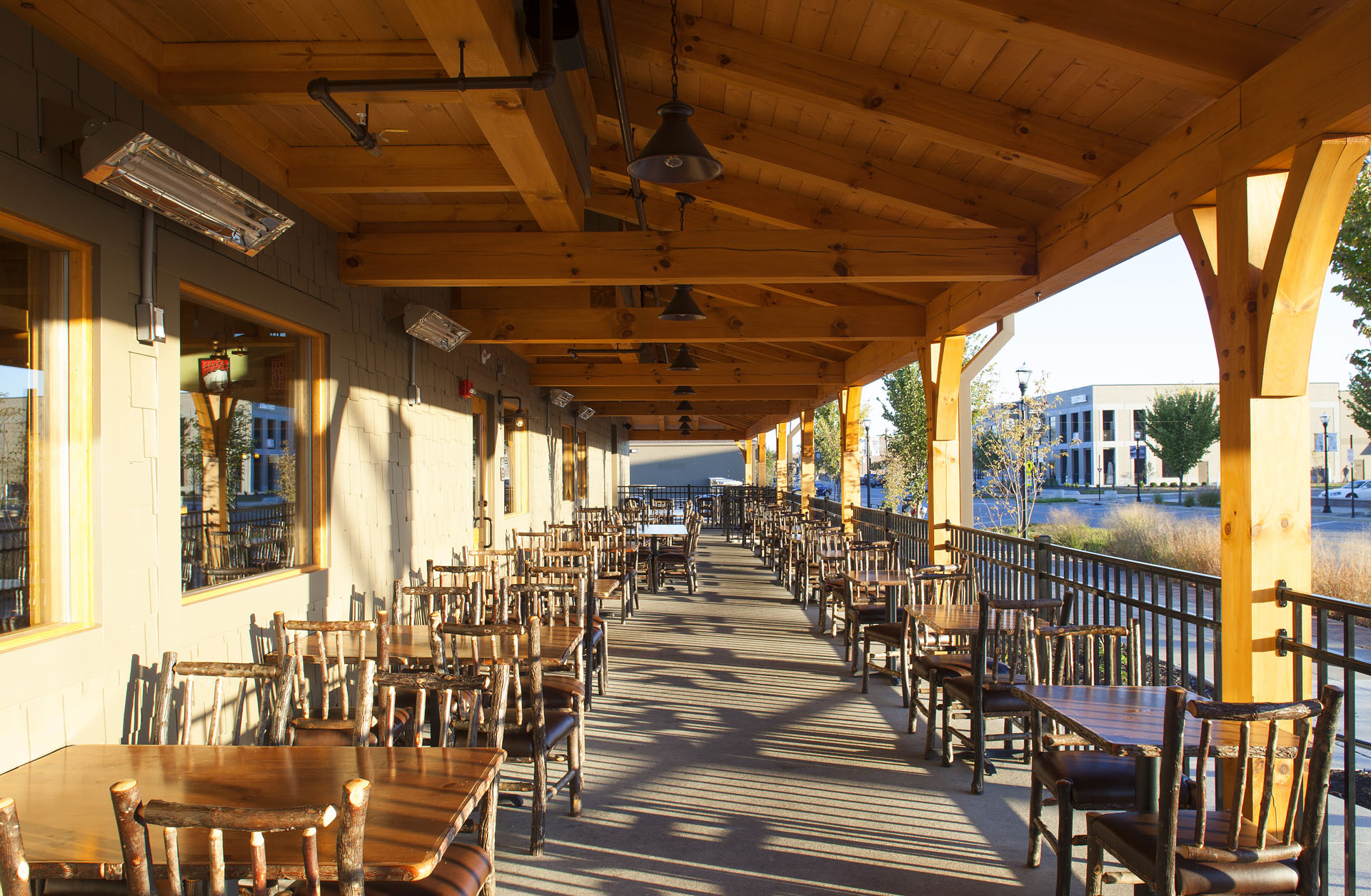 Big Woods Speedway covered porch — rocking chairs beneath exposed timber rafters