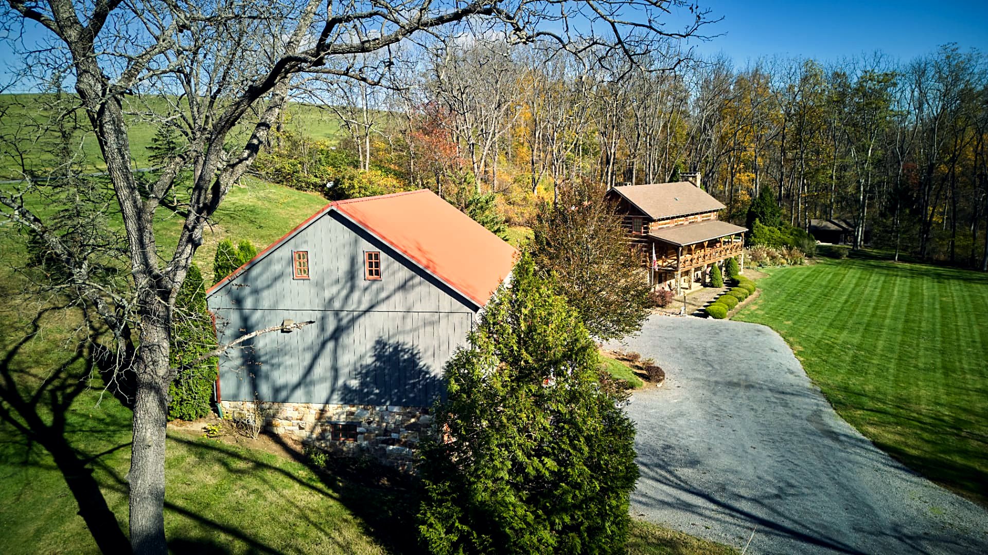 The barn and main house across the mown lawn