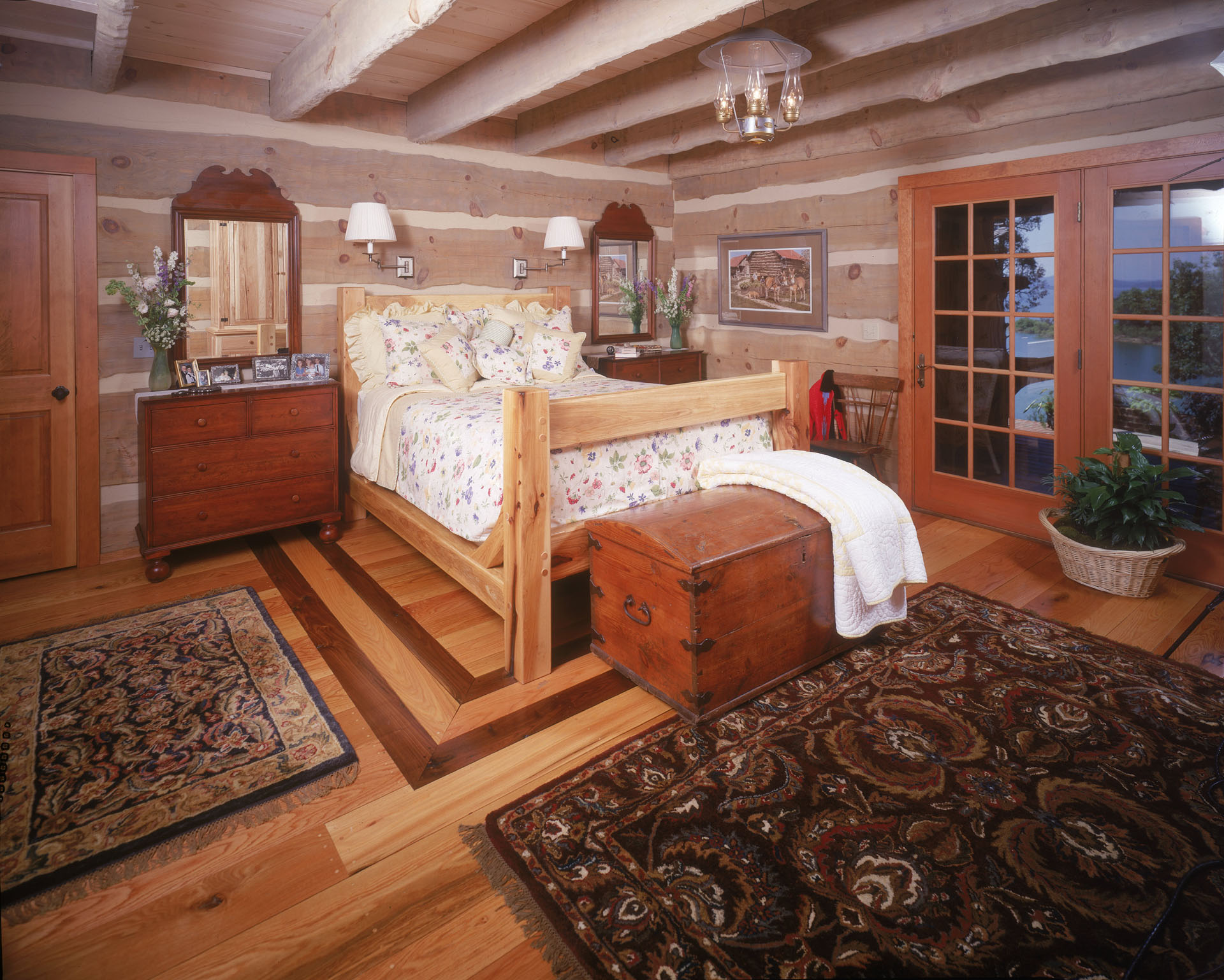 Timber-framed dining room folded into the hand-hewn log shell