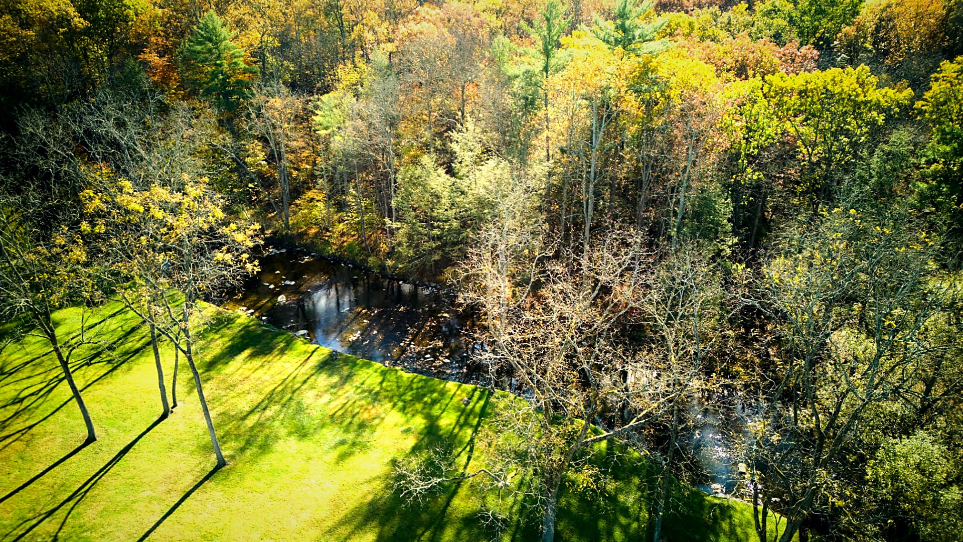 Creek reflections and autumn color below the house
