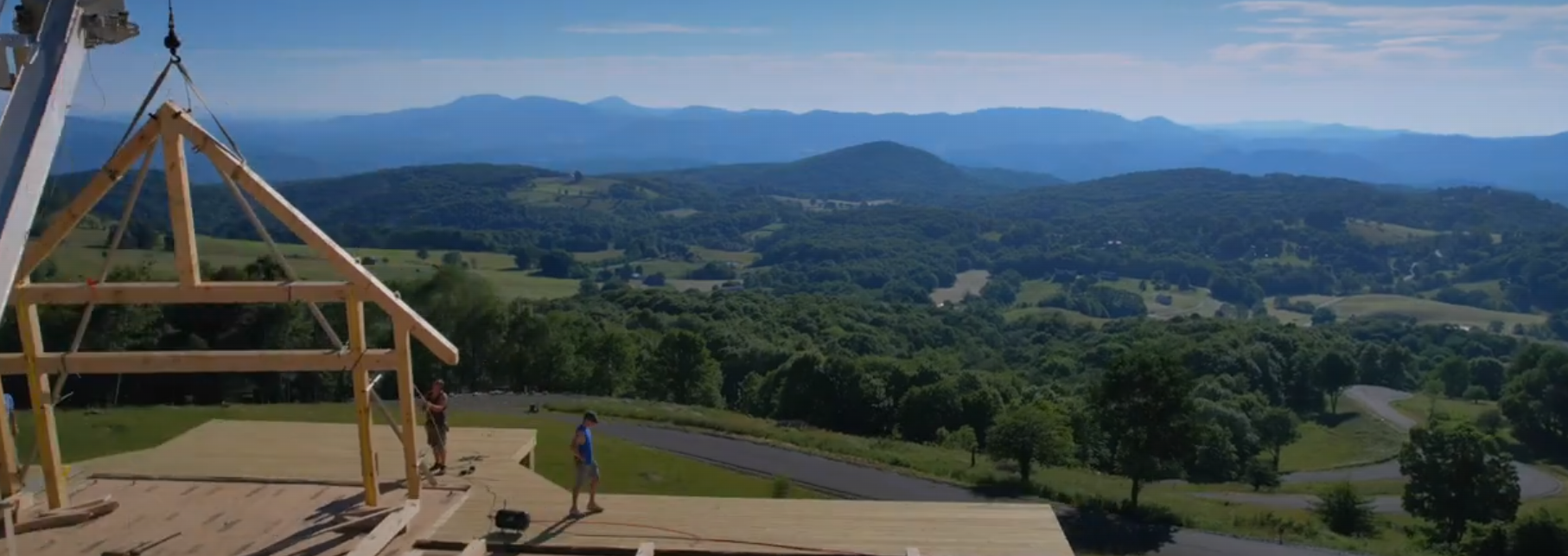 Timber frame bents being raised on a Blue Ridge ridgeline