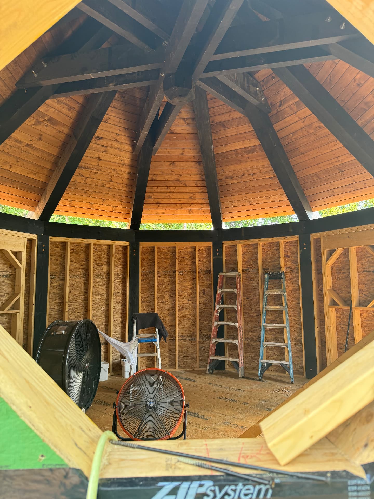 Radial rafters and tongue-and-groove decking forming the treehouse dome ceiling