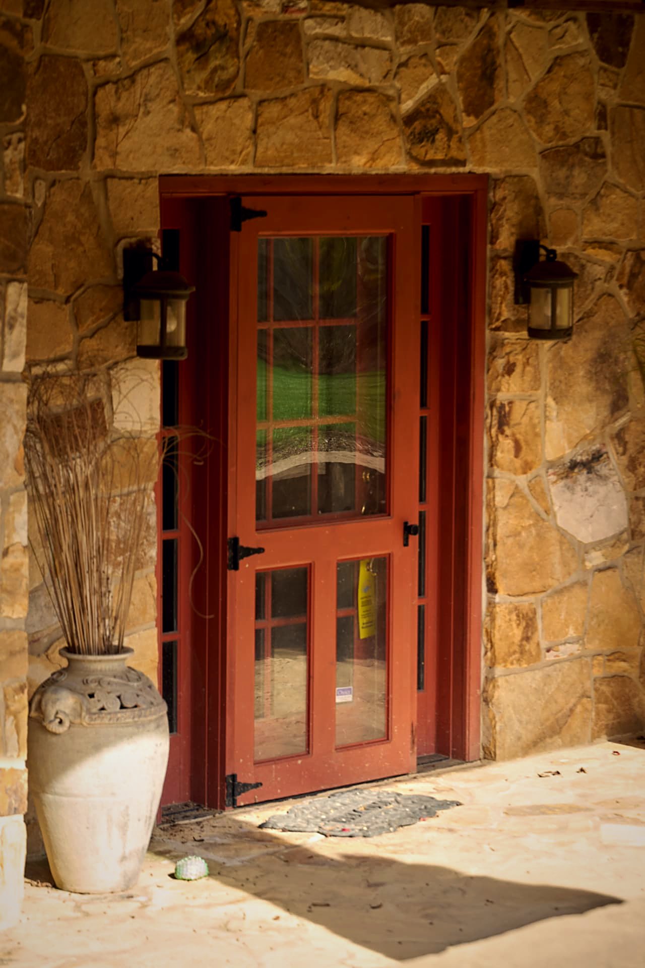 Ember-red glass door set into the stone lower level