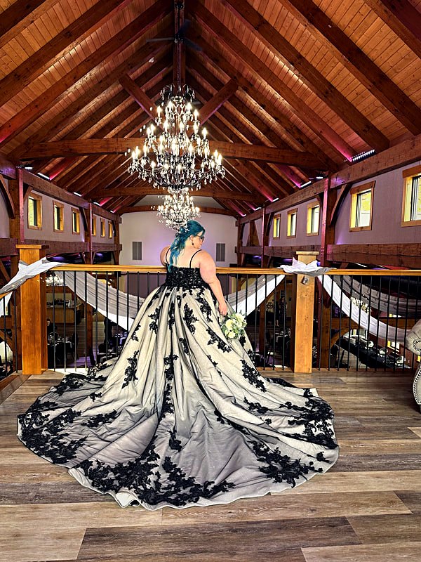 View from the hall floor to the balcony that overlooks the event space and the lake beyond