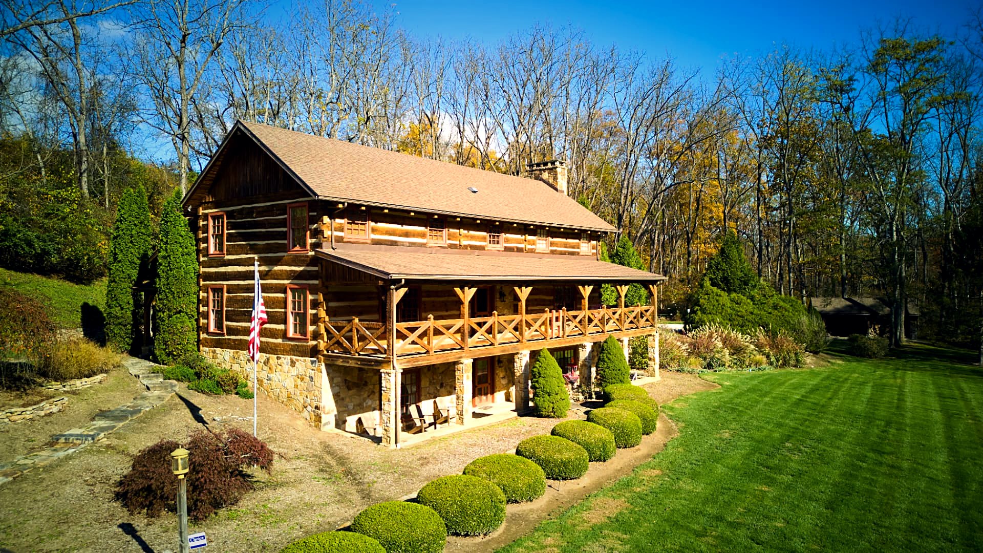 Entry porch at eye level — hewn log joinery and timber posts