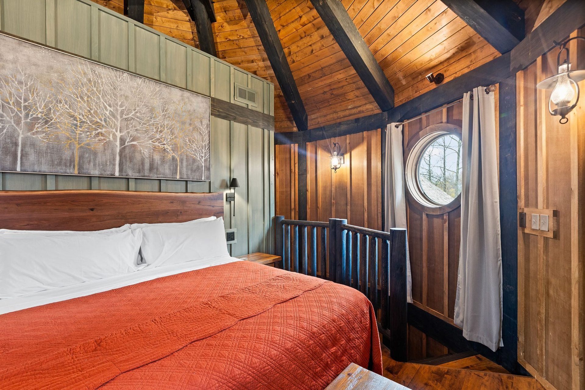 Elven Treehouse bedroom with timber headboard, exposed rafters, and framed botanical panels