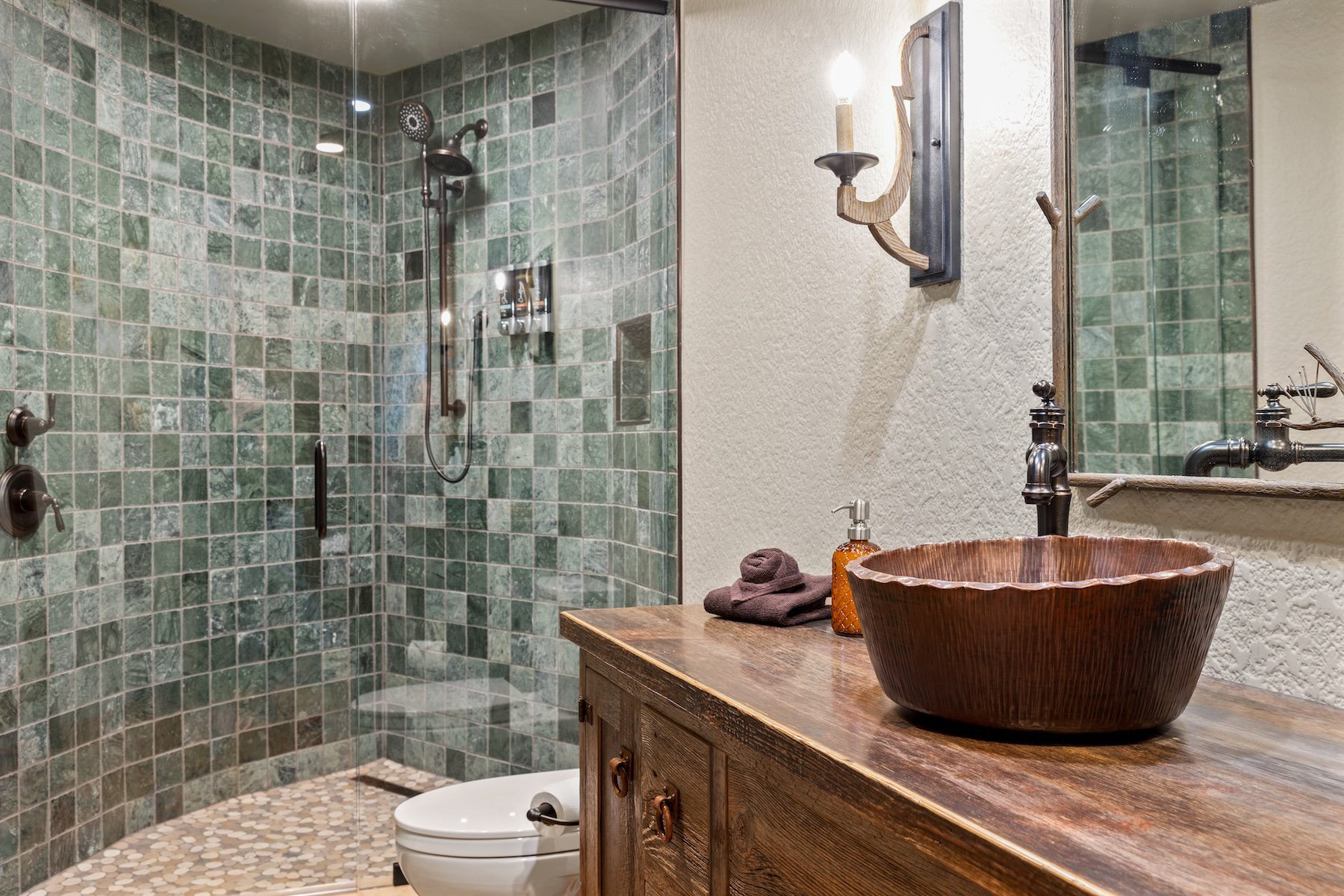 Rustic Elven Treehouse bathroom with green-tiled shower and wooden vanity