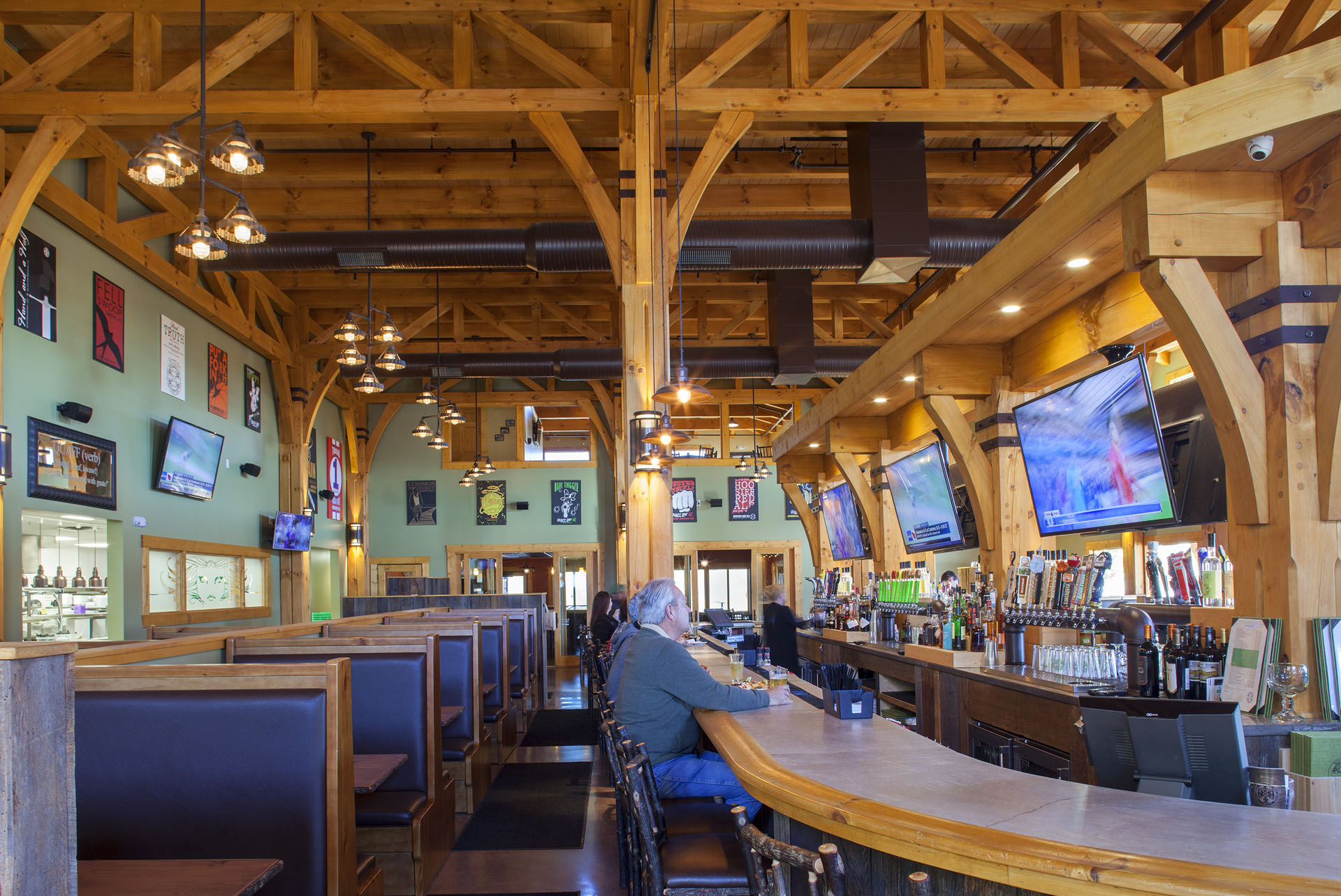 Big Woods Speedway — taproom booths under timber framing