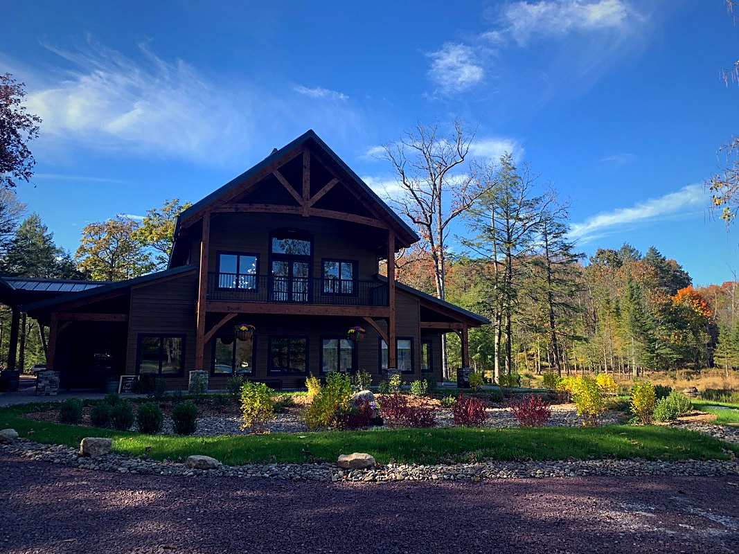 The venue in autumn, timber gables and stone above the landscaped beds
