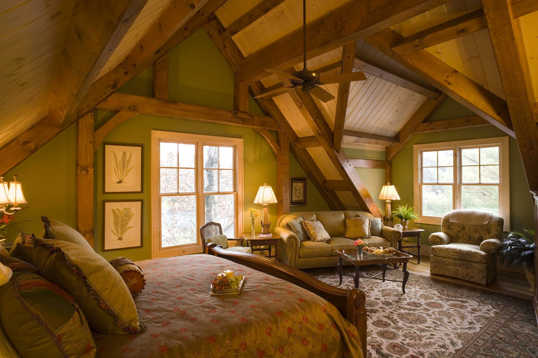 Guest suite with exposed queen-post ceiling and paired French doors to the porch