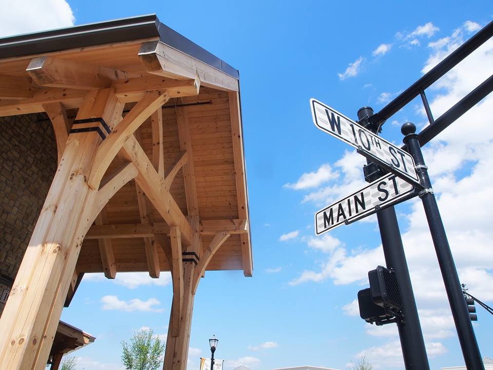 Big Woods Speedway porch bracket detail against the Main Street sign