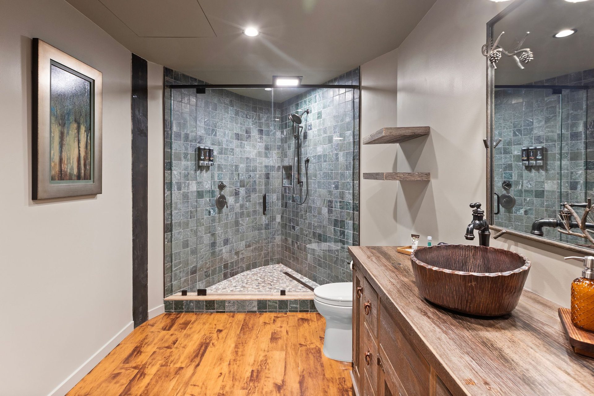 Elven Treehouse bath with glass shower, stone floor, and reclaimed-timber vanity