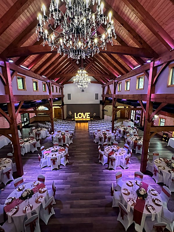 The hall at night with integrated LED accent lighting washing the timber frame in color