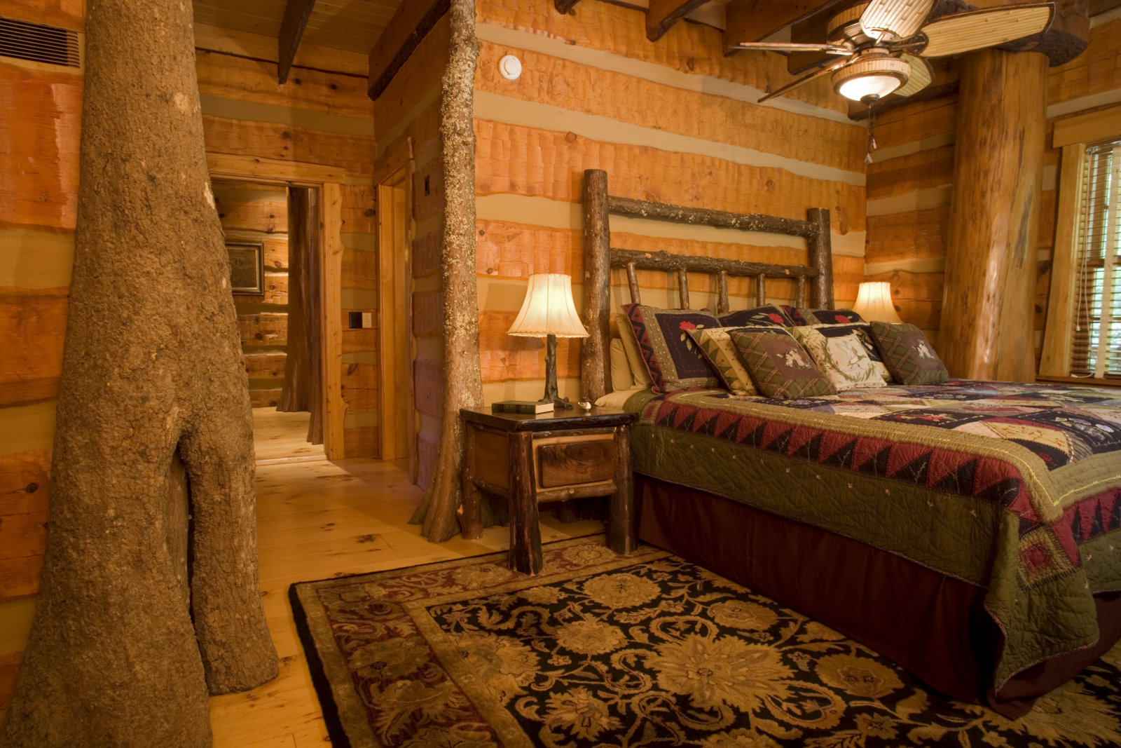 Guest bedroom with cypress tree posts, hewn-log walls, and hickory-post bed