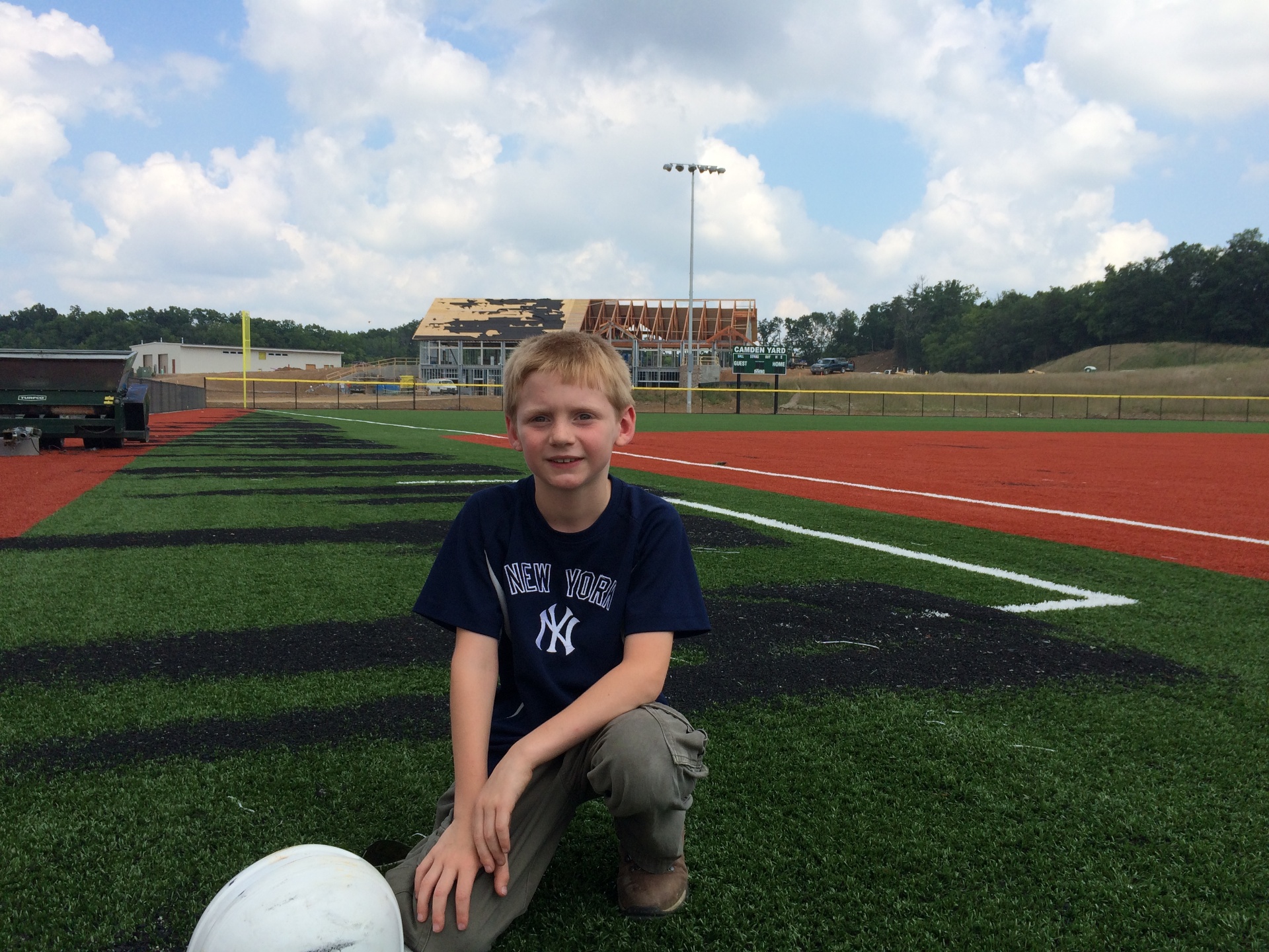 Jack Hall on the Camden Yard field with the clubhouse framing rising behind him, 2015